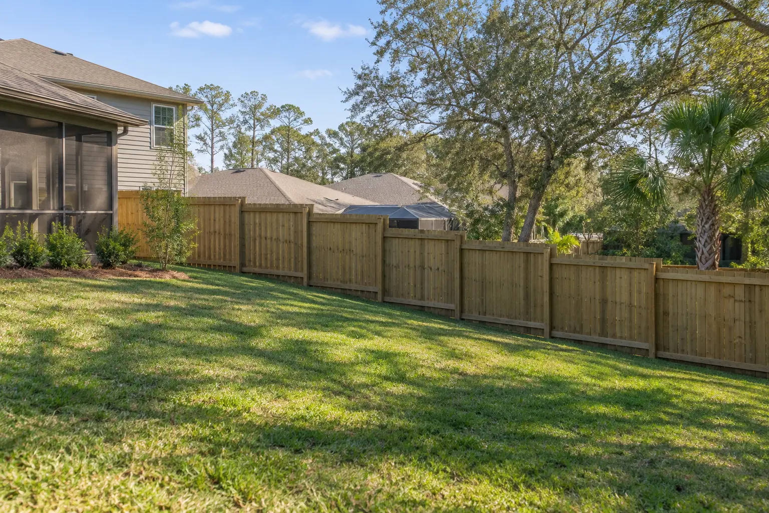 Privacy fence following a sloped Jacksonville Florida backyard